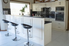 black bar stools behind kitchen counter
