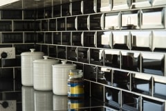 close up of black brick tiled splash back